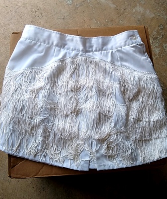 Set of 84 White, Fringed Skirts This is a set of 84 white, fringed used band front skirts make by Ch