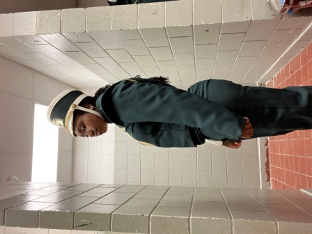 Set of 100 green, white, and gold Furhman marching band uniforms with matching shakos. Must be purch