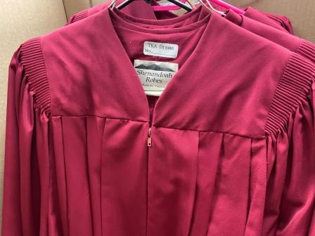 Lot of red choir robes and matching stoles